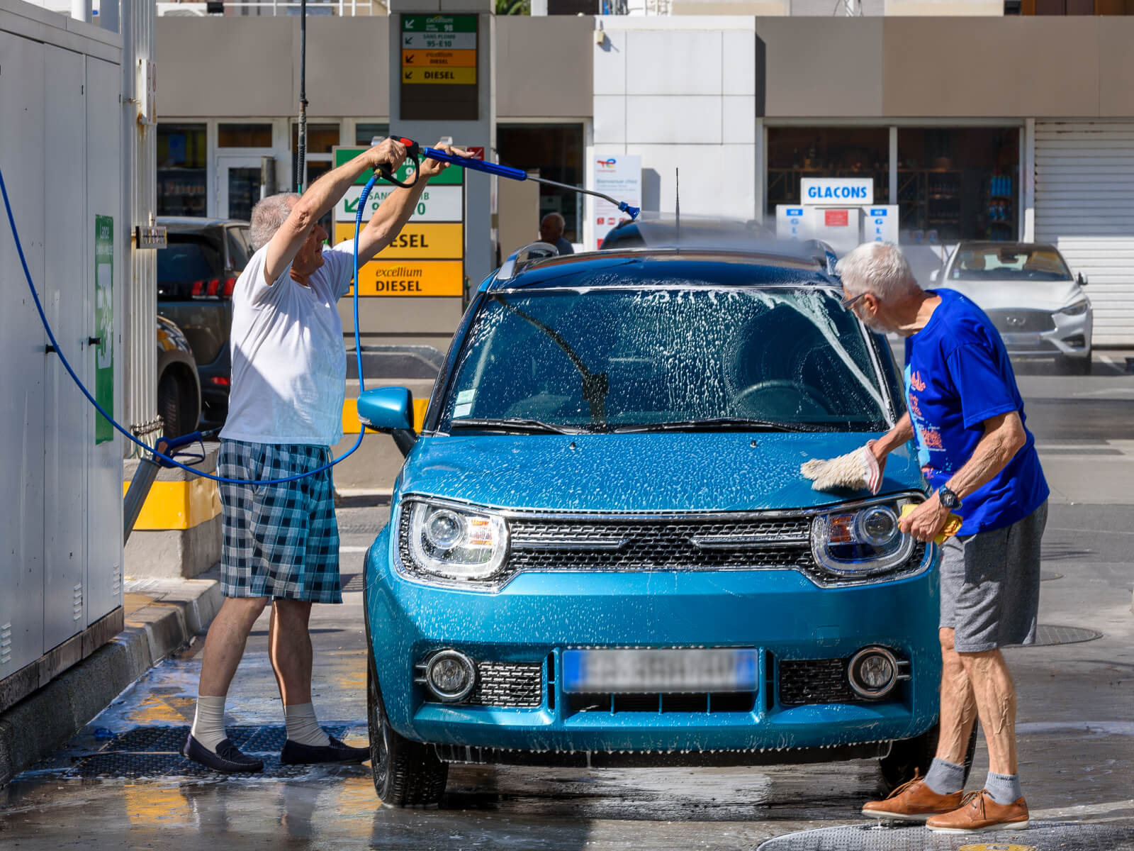Lavage a haute pression d'une voiture bleu chez Wash Total Energies